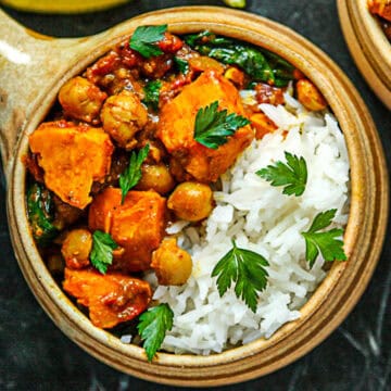 Sweet potato chickpea curry and rice in a pottery bowl.