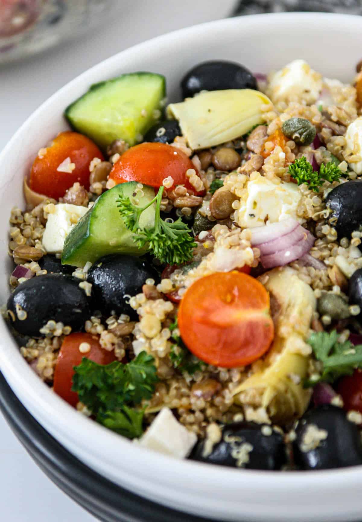 Lentil and quinoa salad in a white bowl.