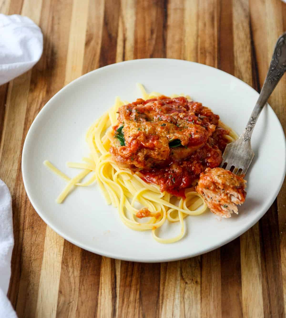 A forkful of food being taken from a plate.