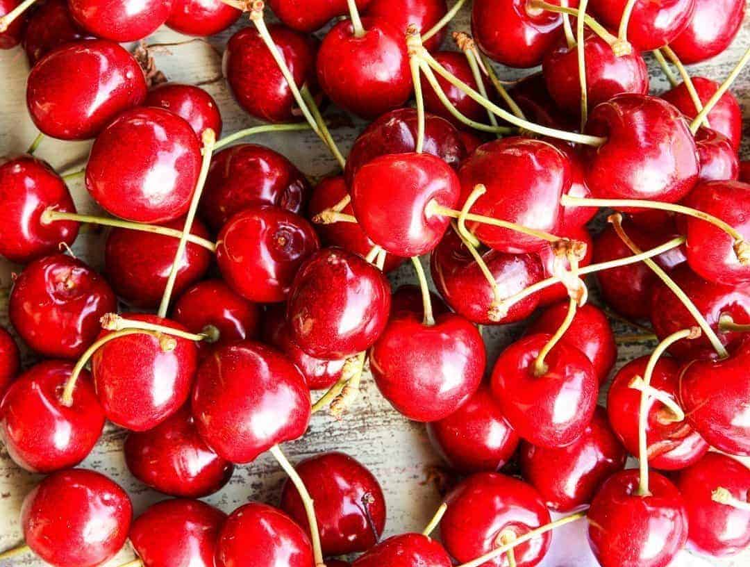 A pile of cherries on a table