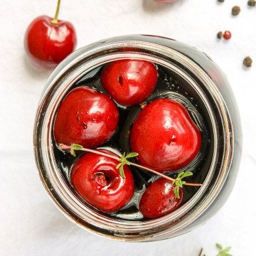 A jar of cherries on a table