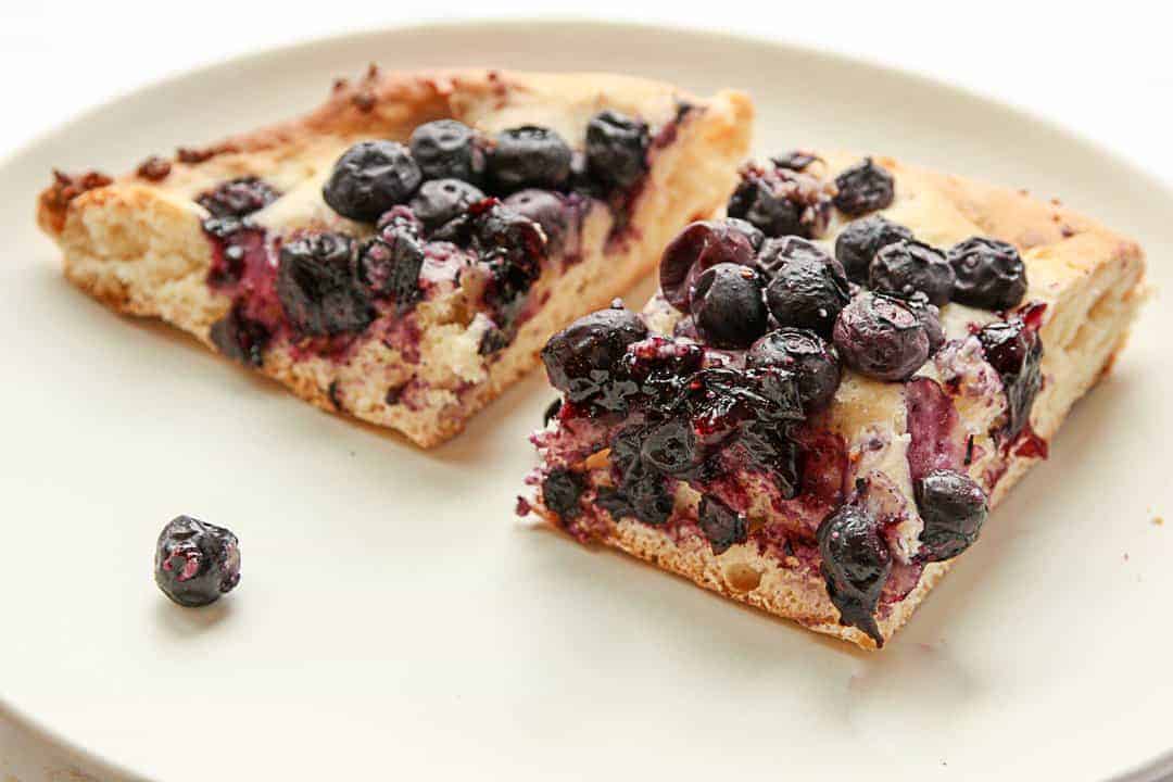 two slices of mustikkapiirakka on a white plate