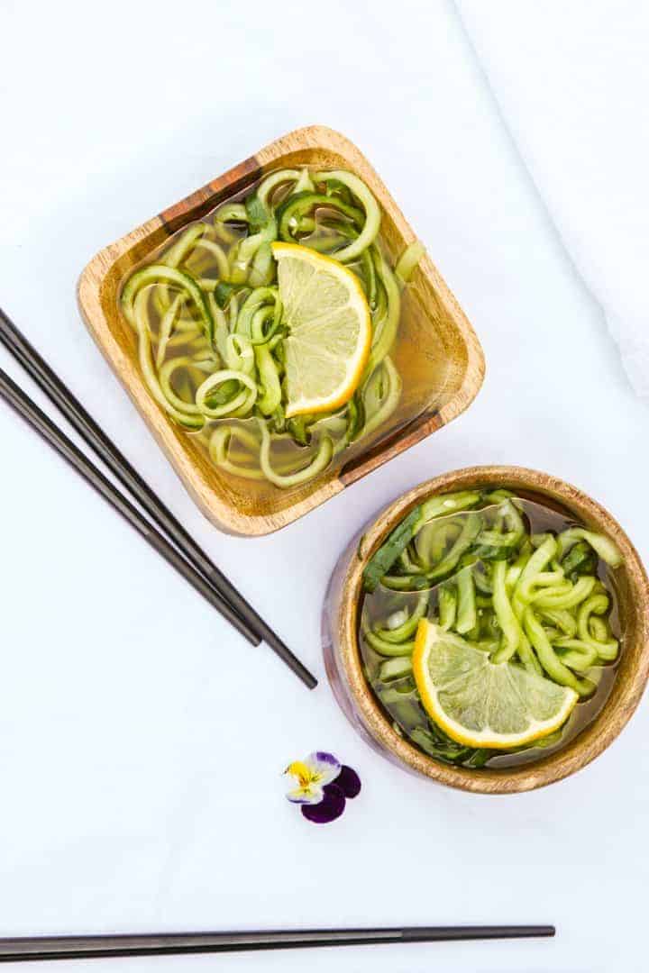 Two wooden bowls of salad on a table