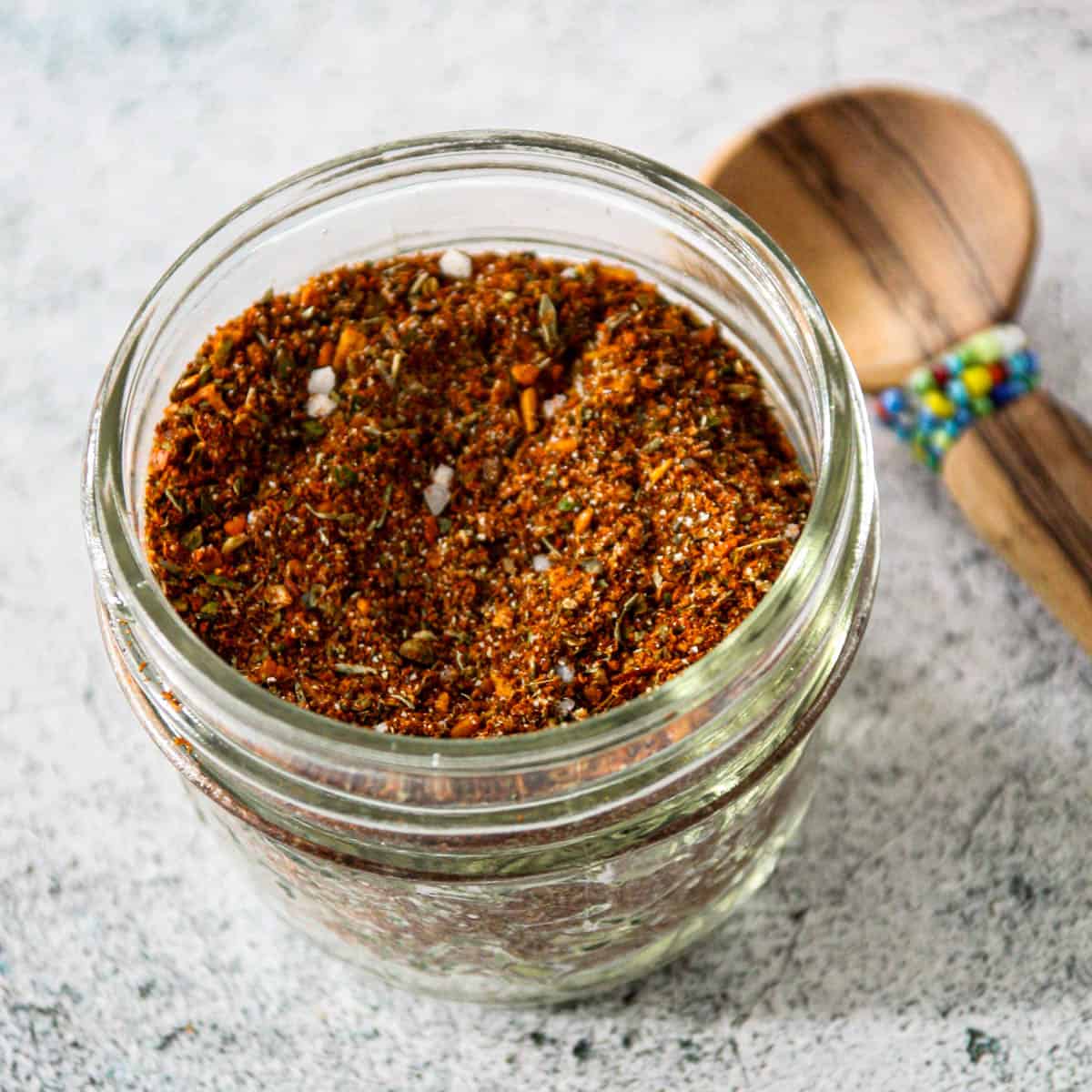 Homemade Cajun seasoning mix in a small glass jar.