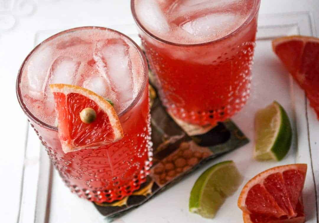 A close up of a glass of grapefruit cocktail