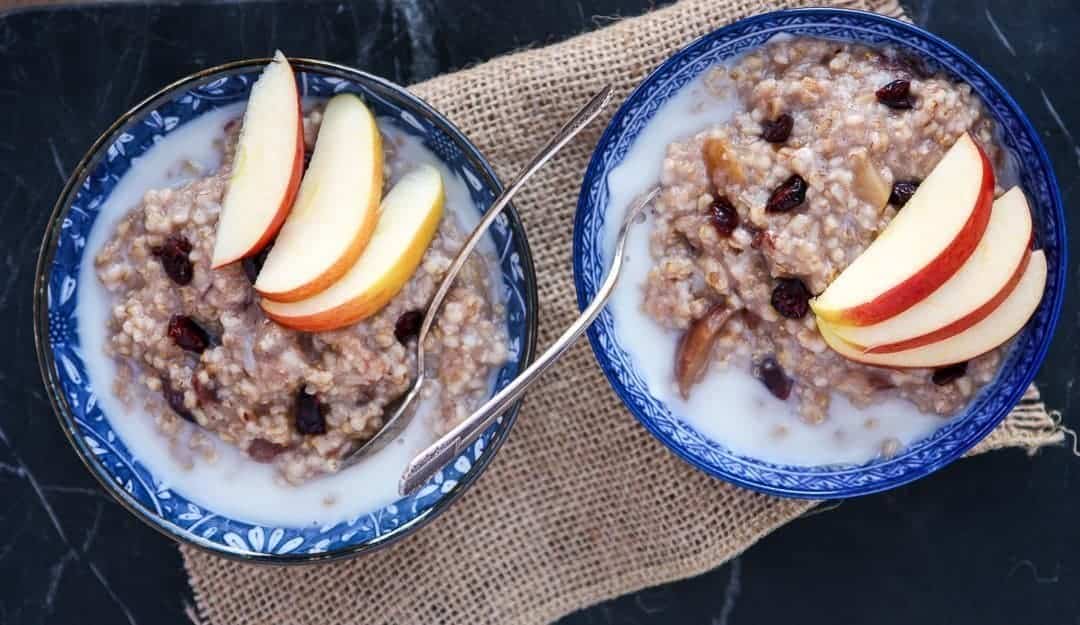 Two bowls of oatmeal with spoons