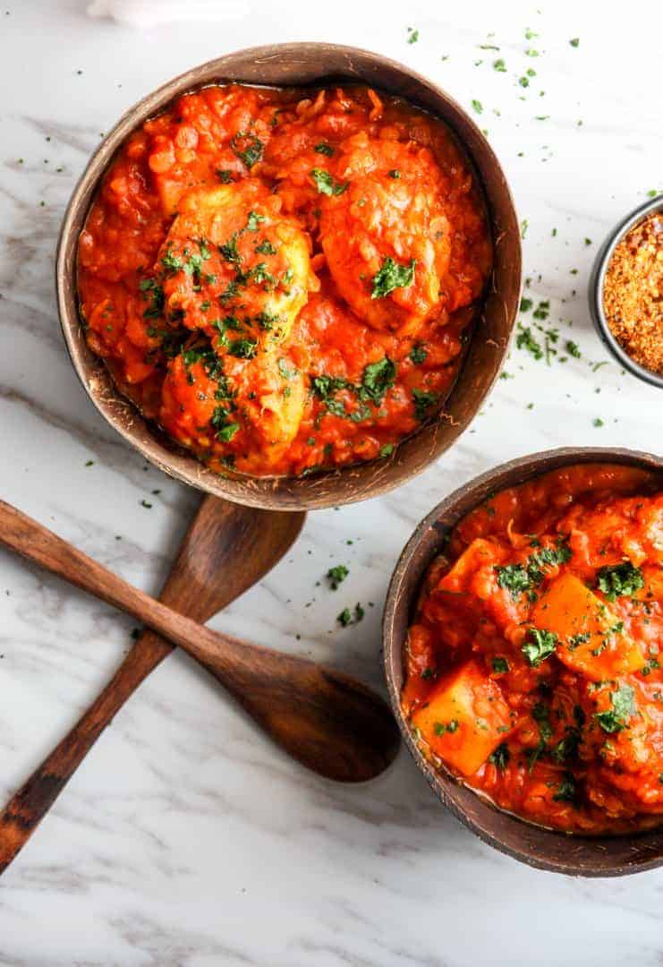 A bowl of chicken stew on a marble counter