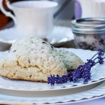 A close up of scones on a plate, with lavendar sprigs