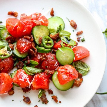 A plate of food, with Salad and Watermelon
