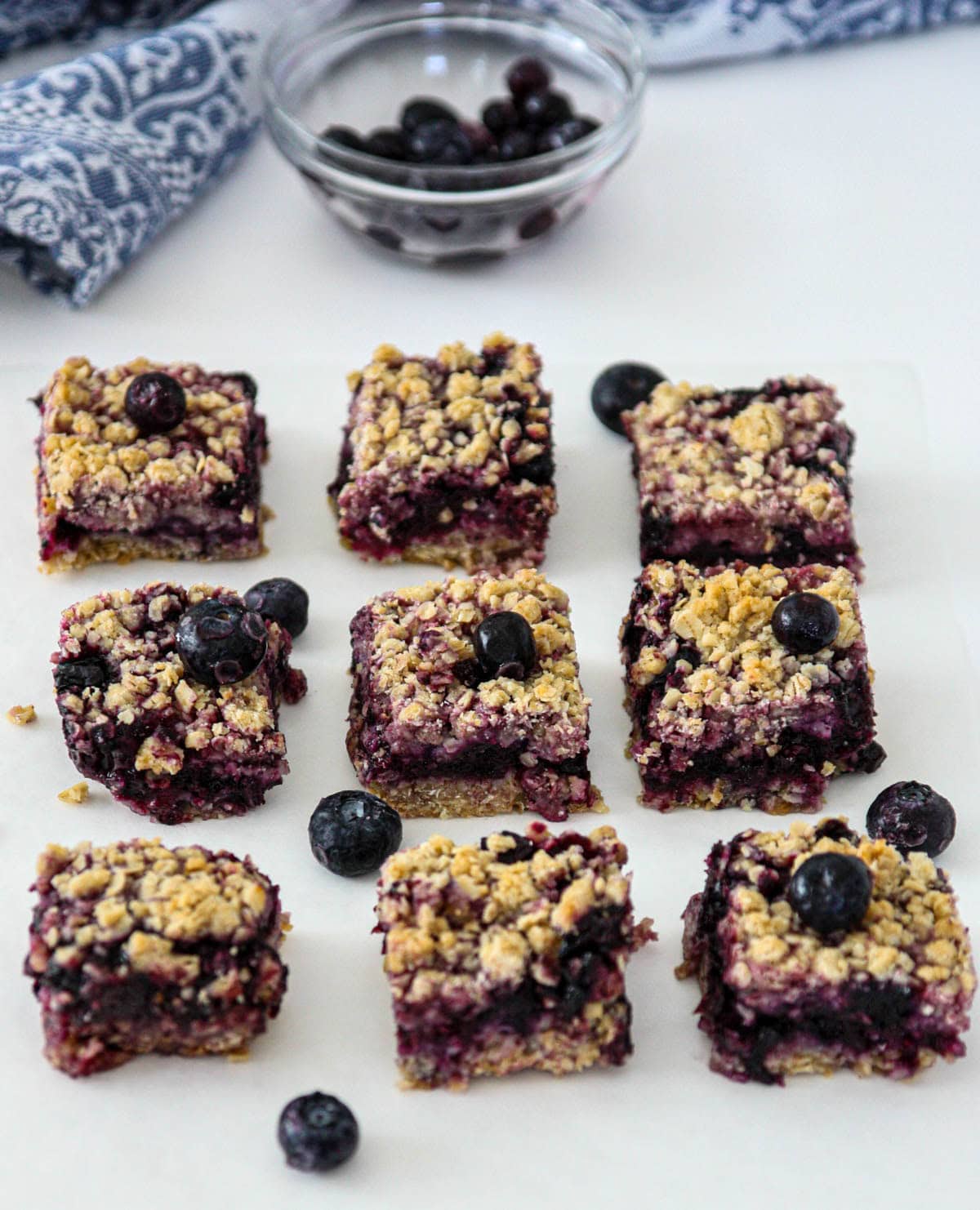 Blueberry oatmeal bars on a white counter top.