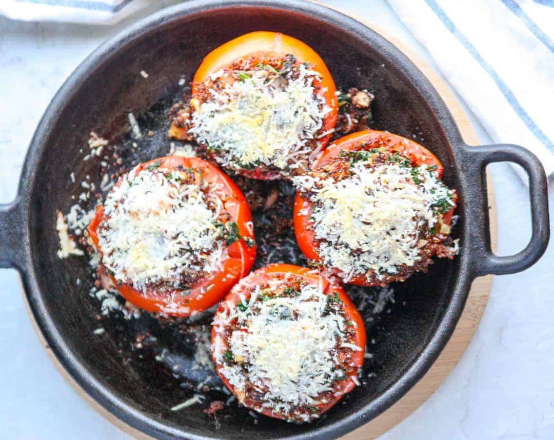 Four stuffed tomatoes in a skillet