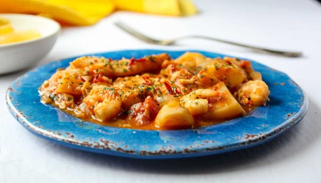 A plate of food on a table, with Fish stew
