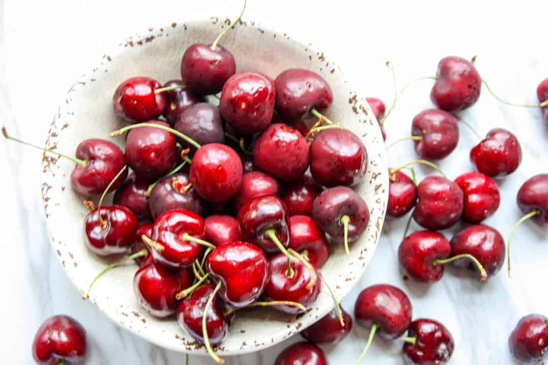Cherries in a bowl on a table