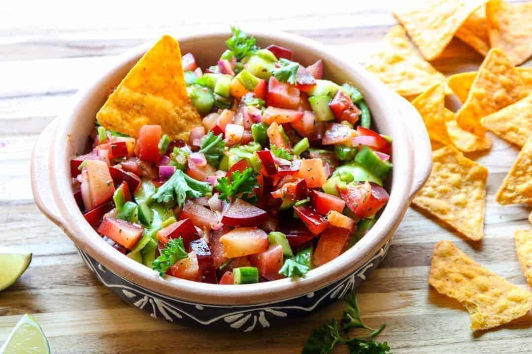 A bowl of salsa, with Tortilla chip