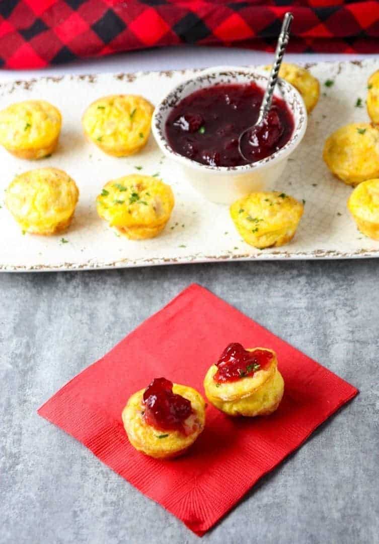 A tray of food on a table, with Quiche and Cranberry sauce