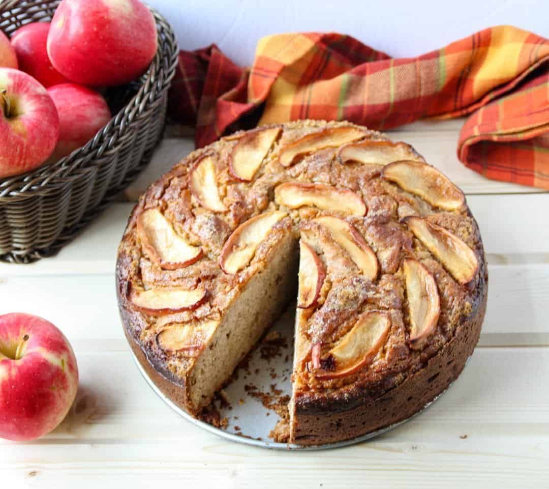 A cake on a plate with a slice cut out