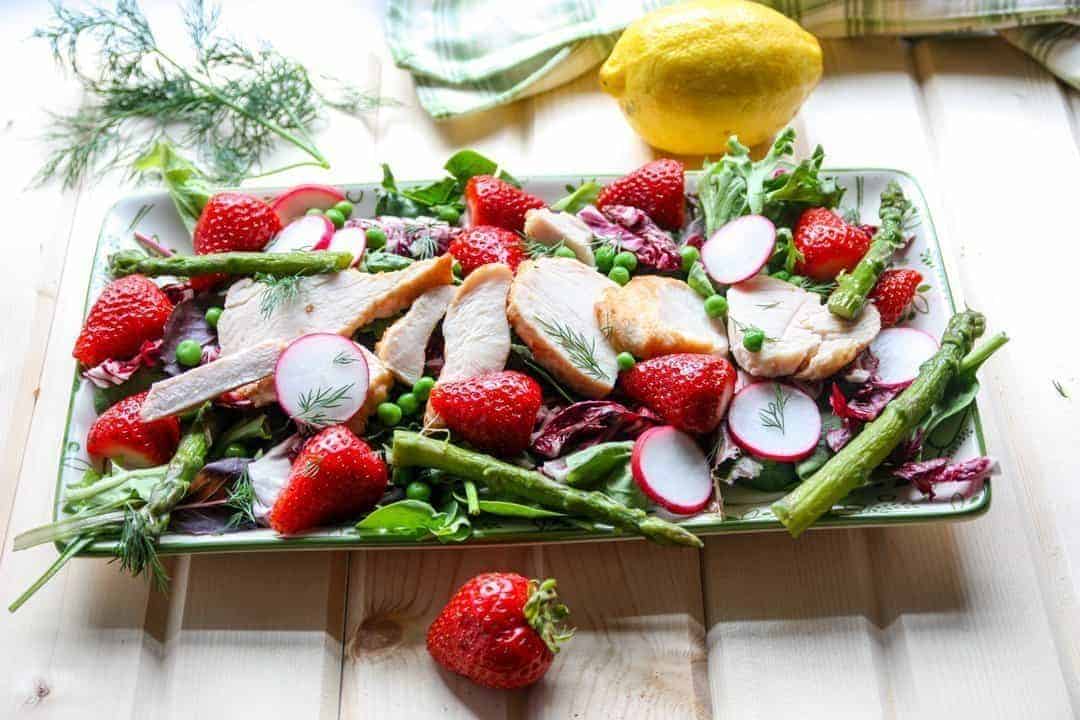 Salad with strawberries, spring vegetables, and chicken