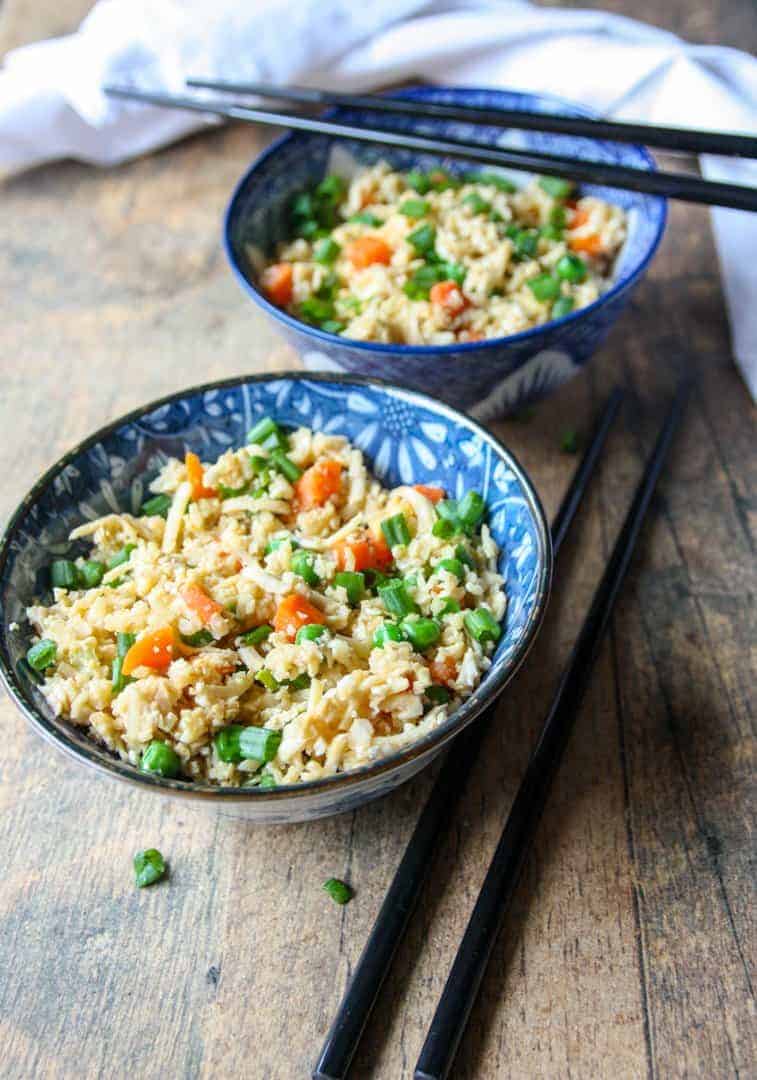 Two bowls of cauliflower rice and vegetables
