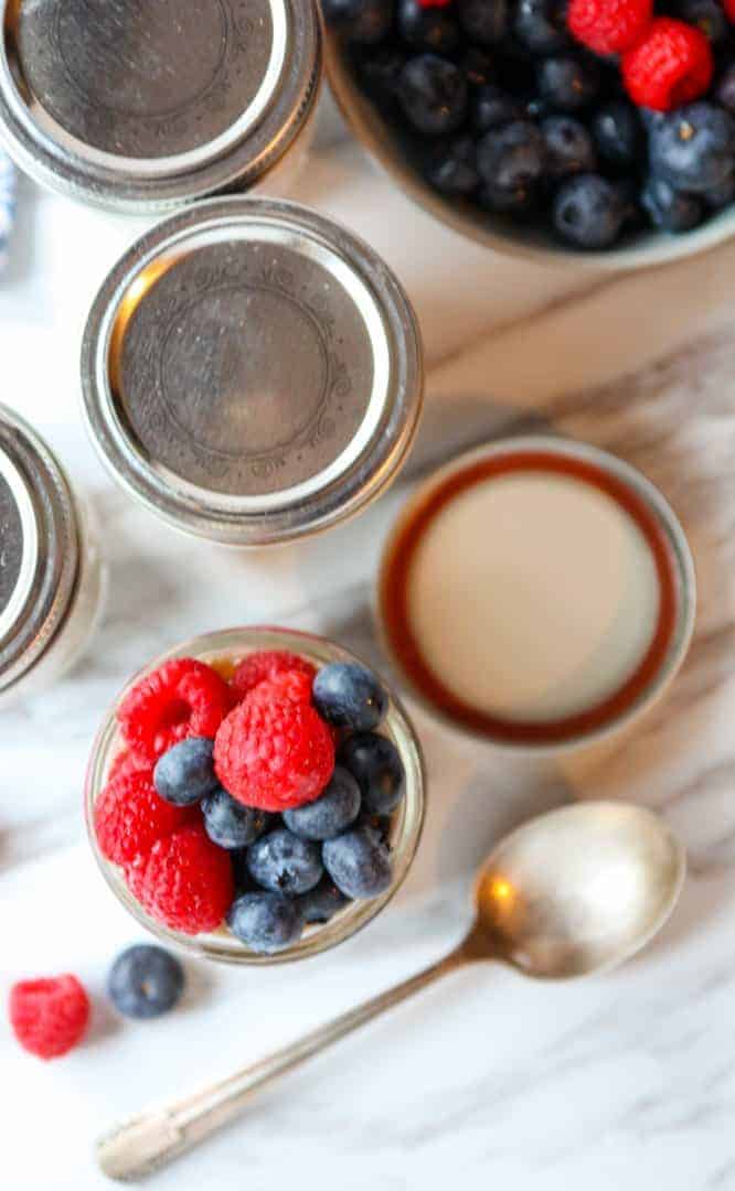 Raspberries and blueberries in a jar on a table