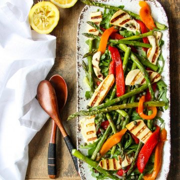 Platter of roasted peppers, asparagus, and cheese.
