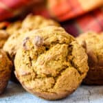 An oat flour pumpkin muffin on a marble countertop.
