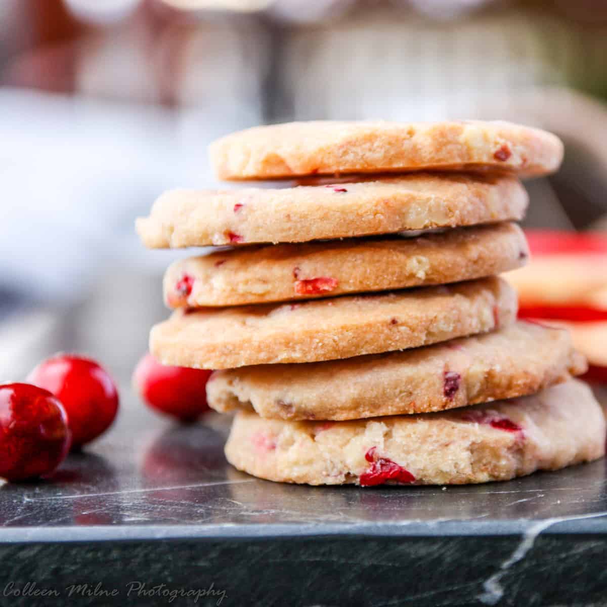 Cookies stacked in a pile on a countertop.