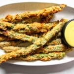 A close up of fried asparagus on a plate.