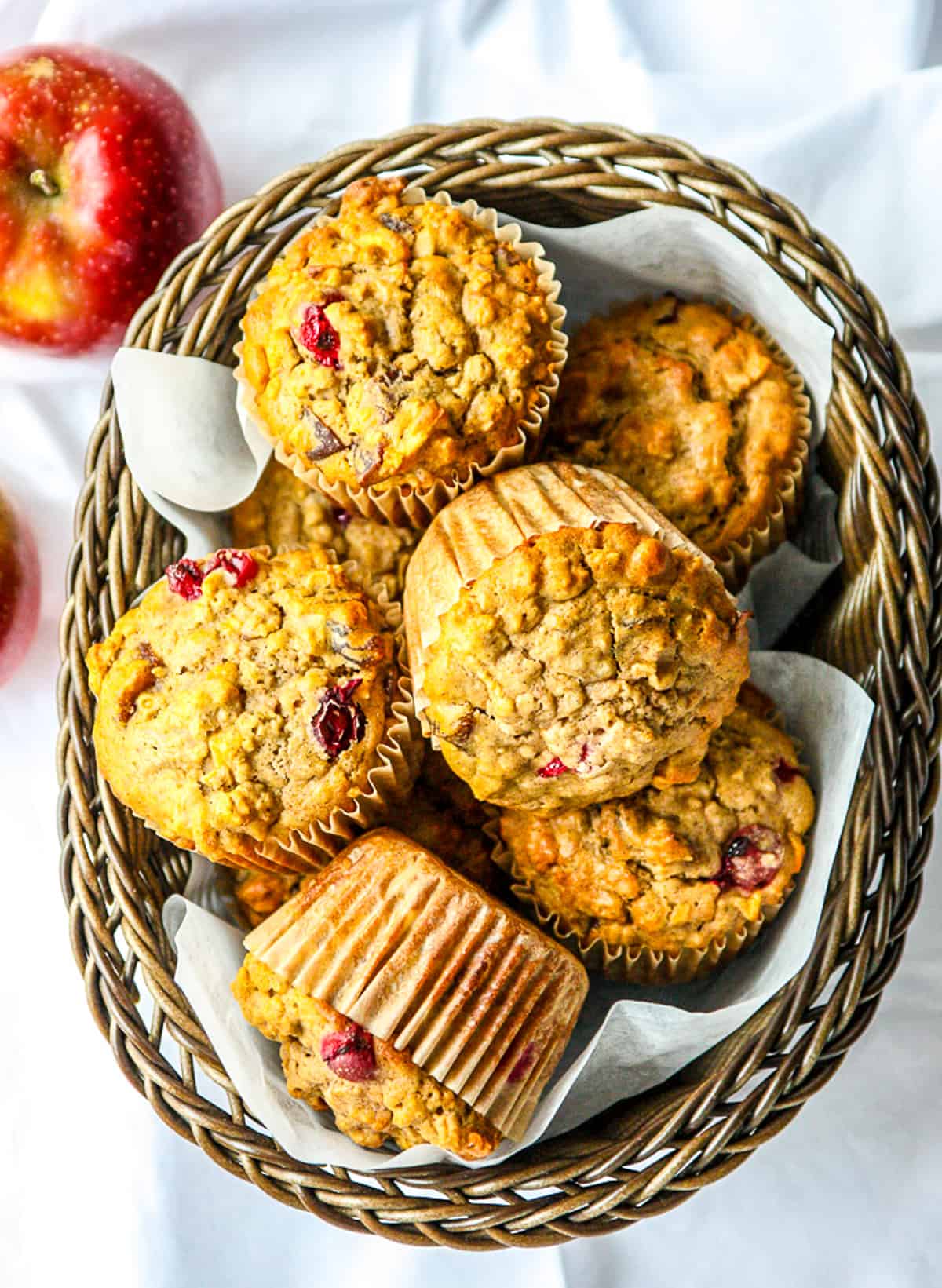 A basket filled with cranberry oatmeal muffins.