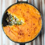 Sweet Potato Shepherd's Pie in a cast iron pan with one slice removed.