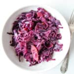 Braised red cabbage in a white bowl.