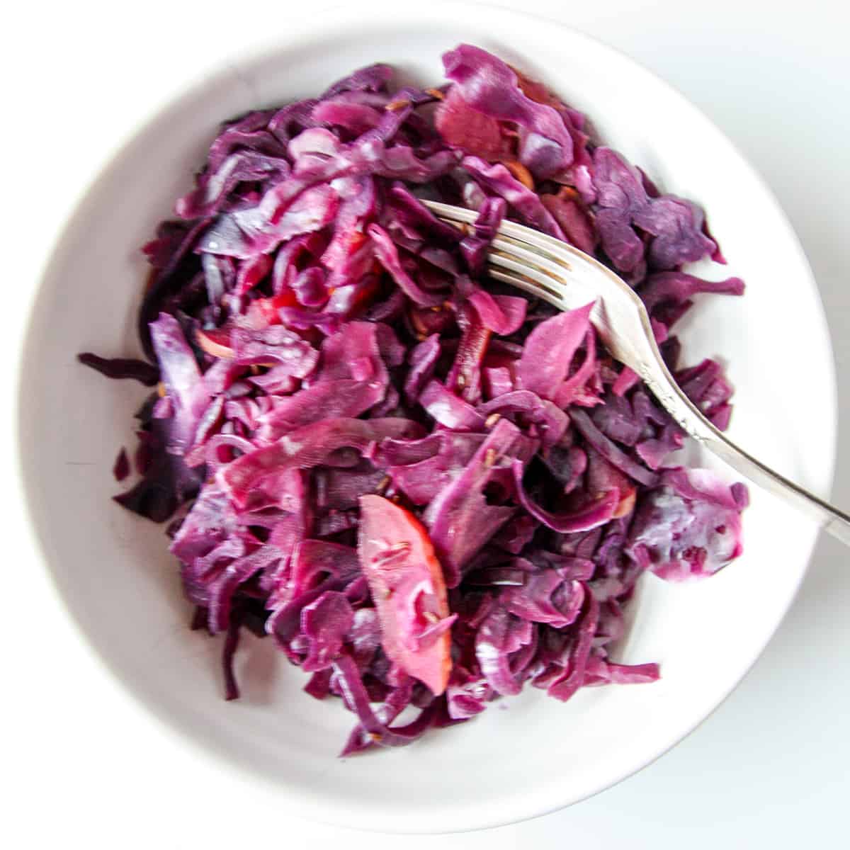 Braised cabbage in a white bowl.