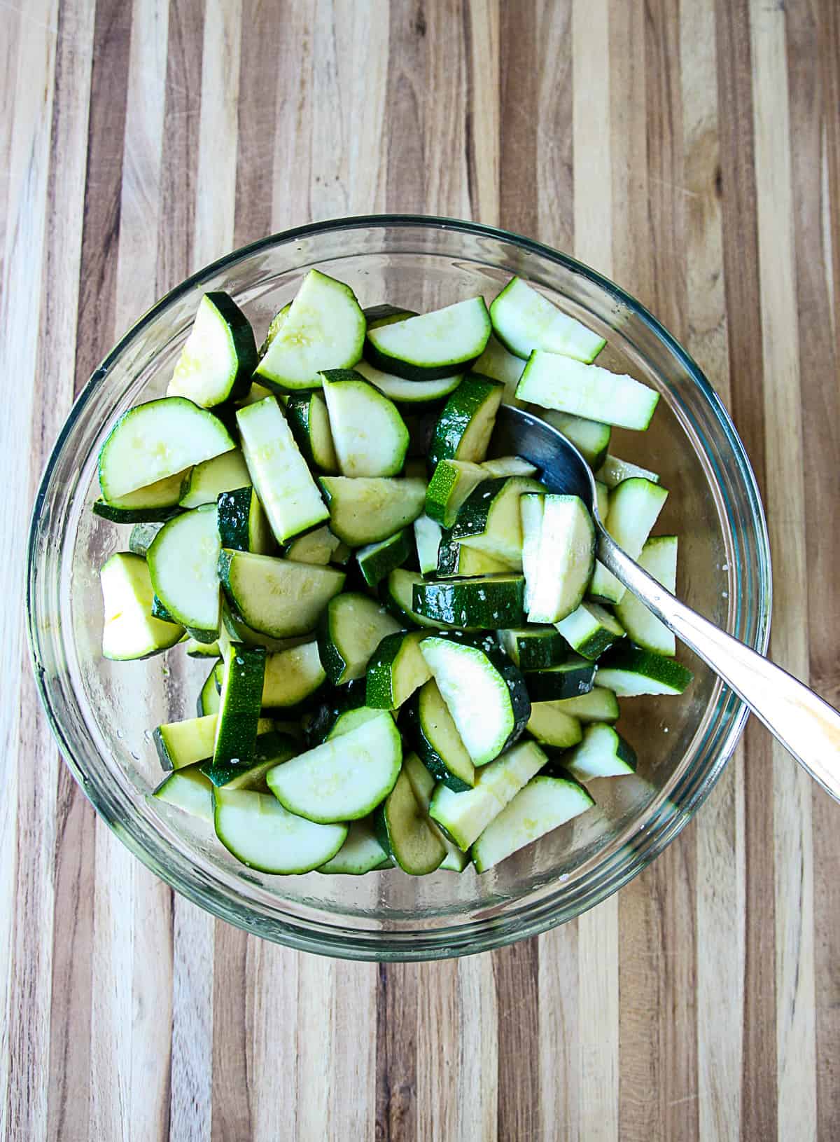 The ingredients being tossed together in a glass bowl.