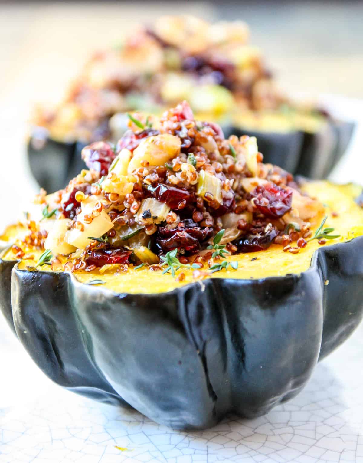 Half of an air fried acorn squash stuffed with quinoa, apples, walnuts and cranberries.