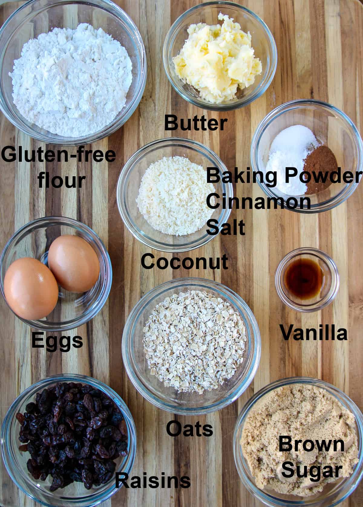 All of the ingredients needed to make the recipe in glass dishes on a wooden board.