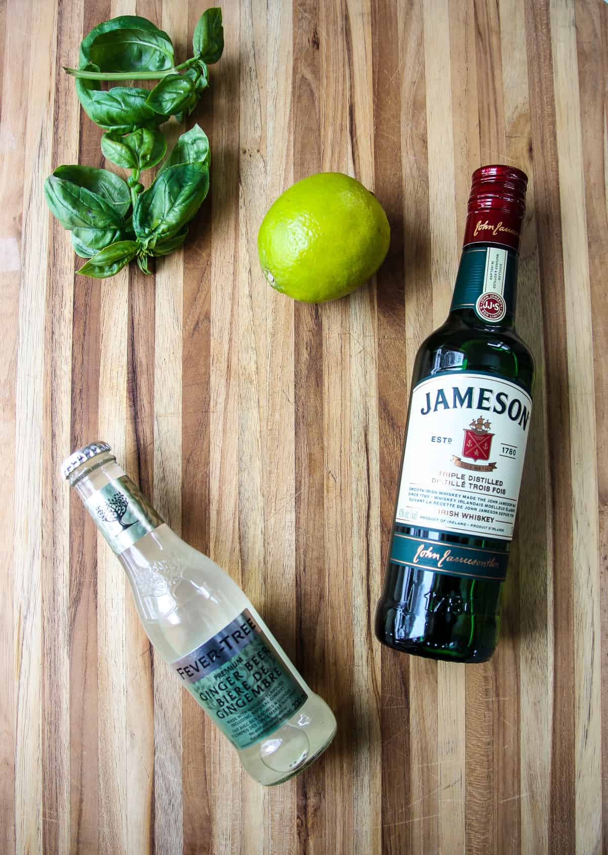 The ingredients for making this cocktail on a wooden board.