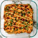 Spicy salmon sushi bake casserole in a glass baking dish.