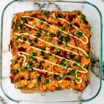 Spicy salmon sushi bake casserole in a glass baking dish.