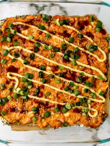 Spicy salmon sushi bake casserole in a glass baking dish.