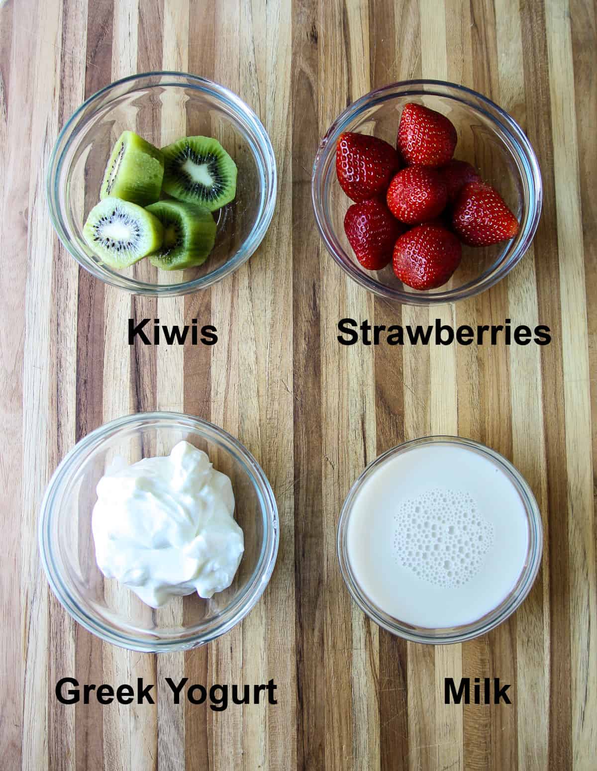 The four ingredients needed to make this recipe in glass bowls on a wooden board.

