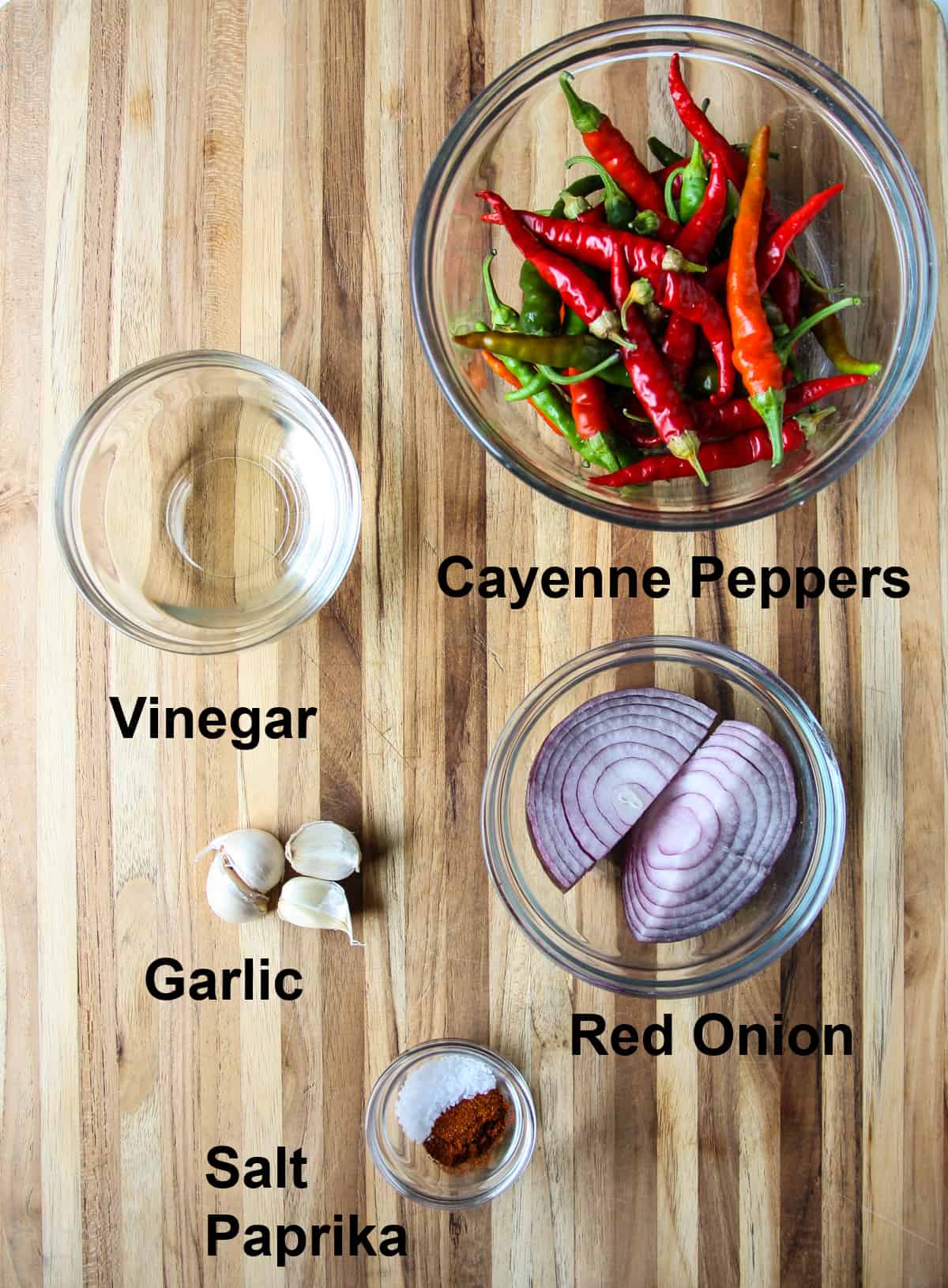 The ingredients to make this recipe in glass bowls on a wooden board.