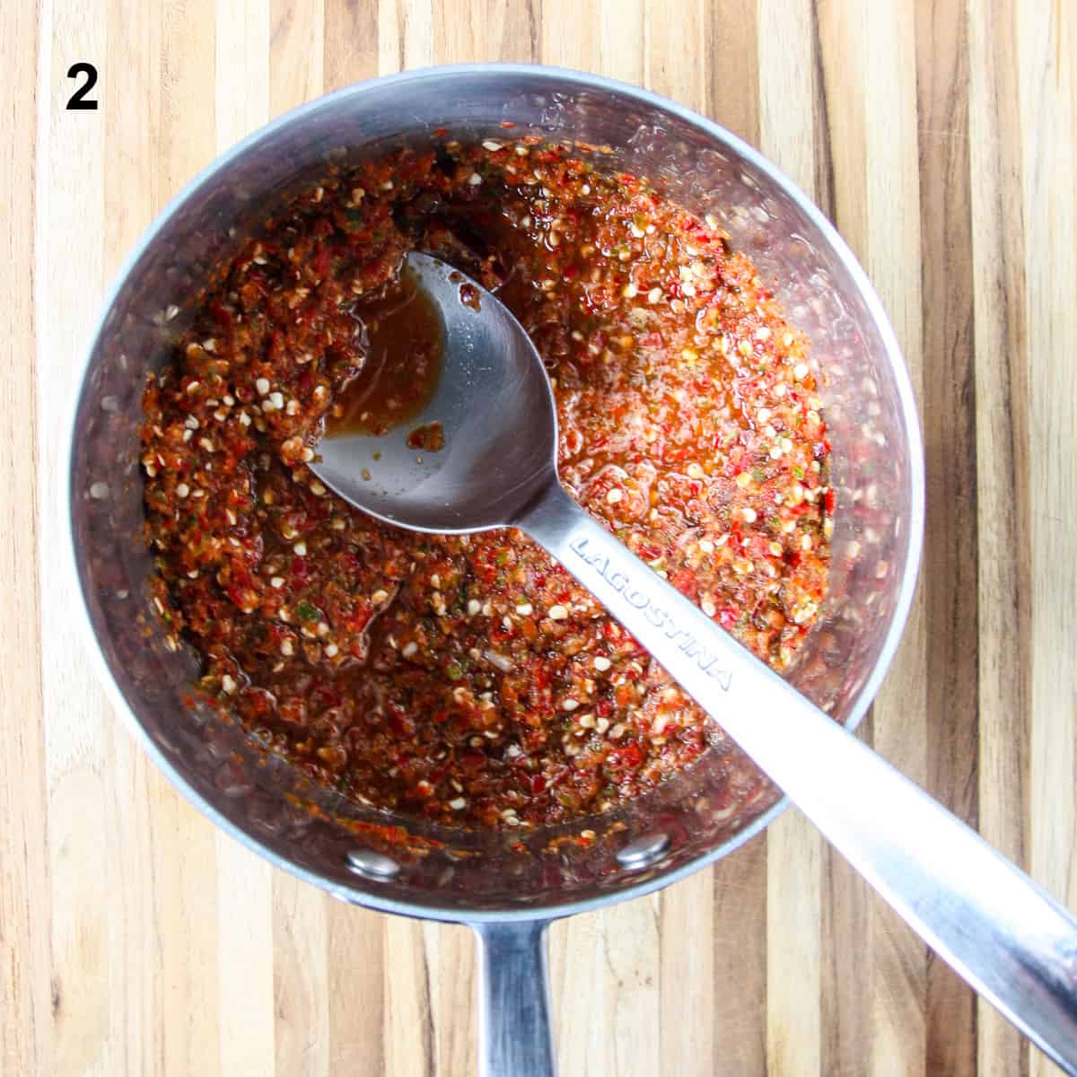 The ingredients in a stainless steel saucepan with the vinegar added.