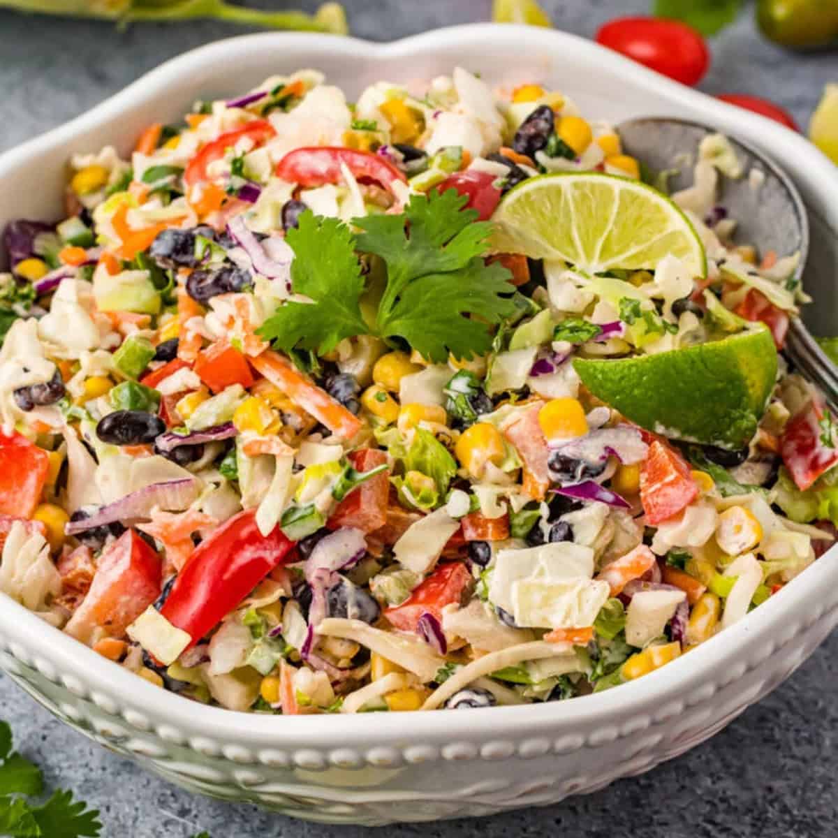 Colorful Mexican coleslaw in a white bowl.