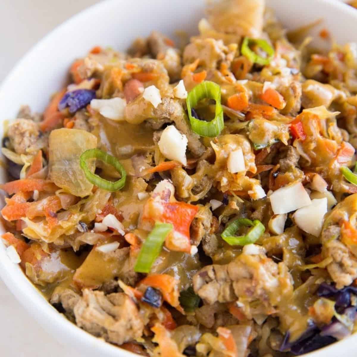 Thai ground turkey and cabbage in a white bowl.