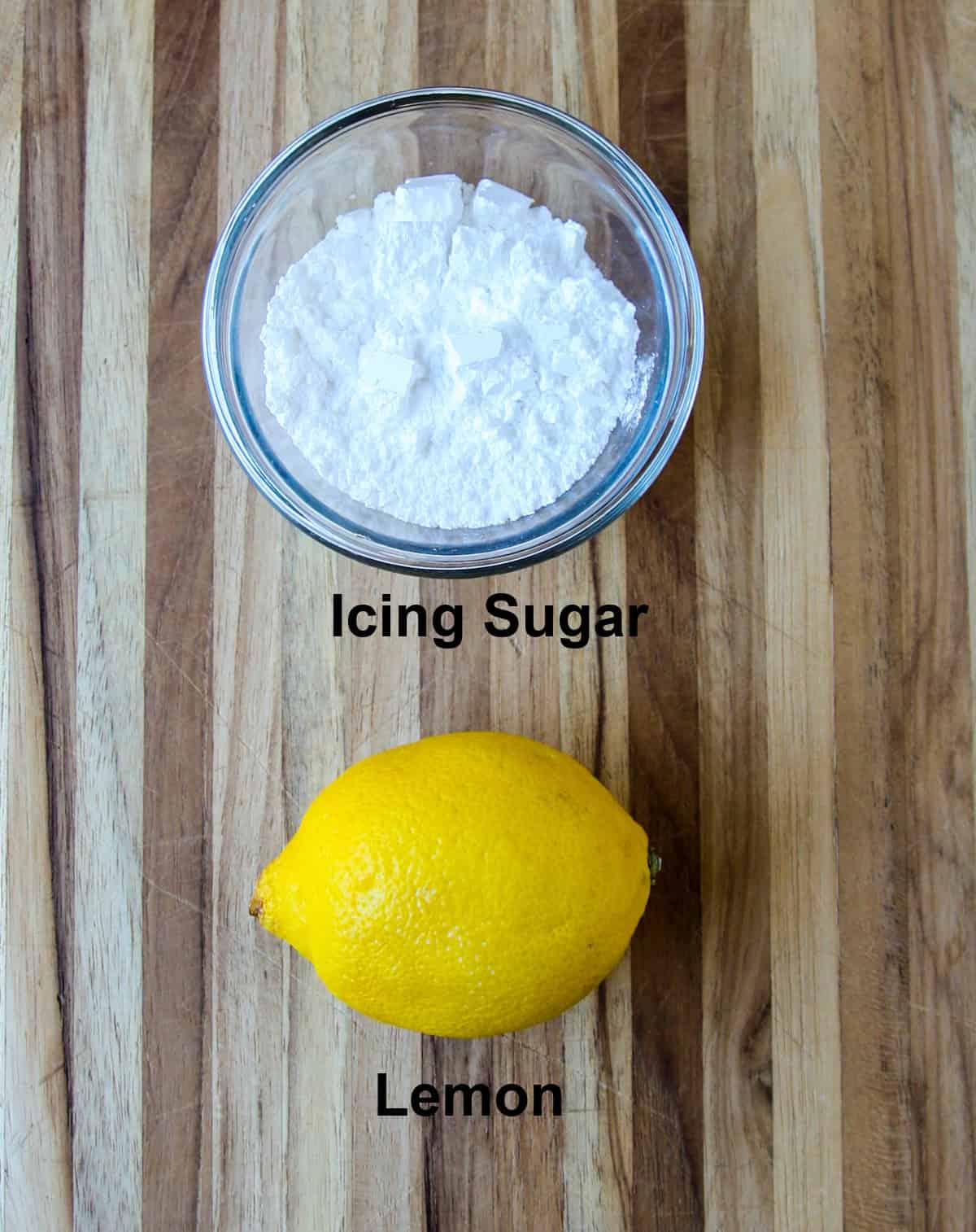 A bowl of icing sugar and a lemon.