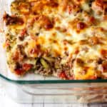 Ground beef zucchini casserole in a glass baking dish.