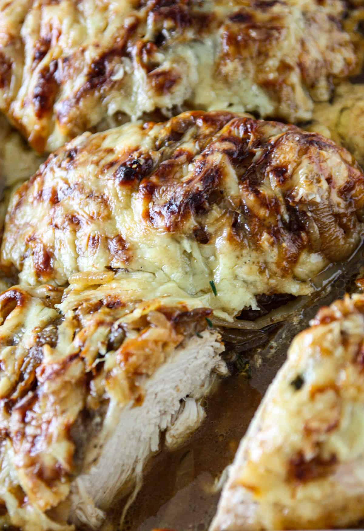 French onion chicken bake in a white baking dish.