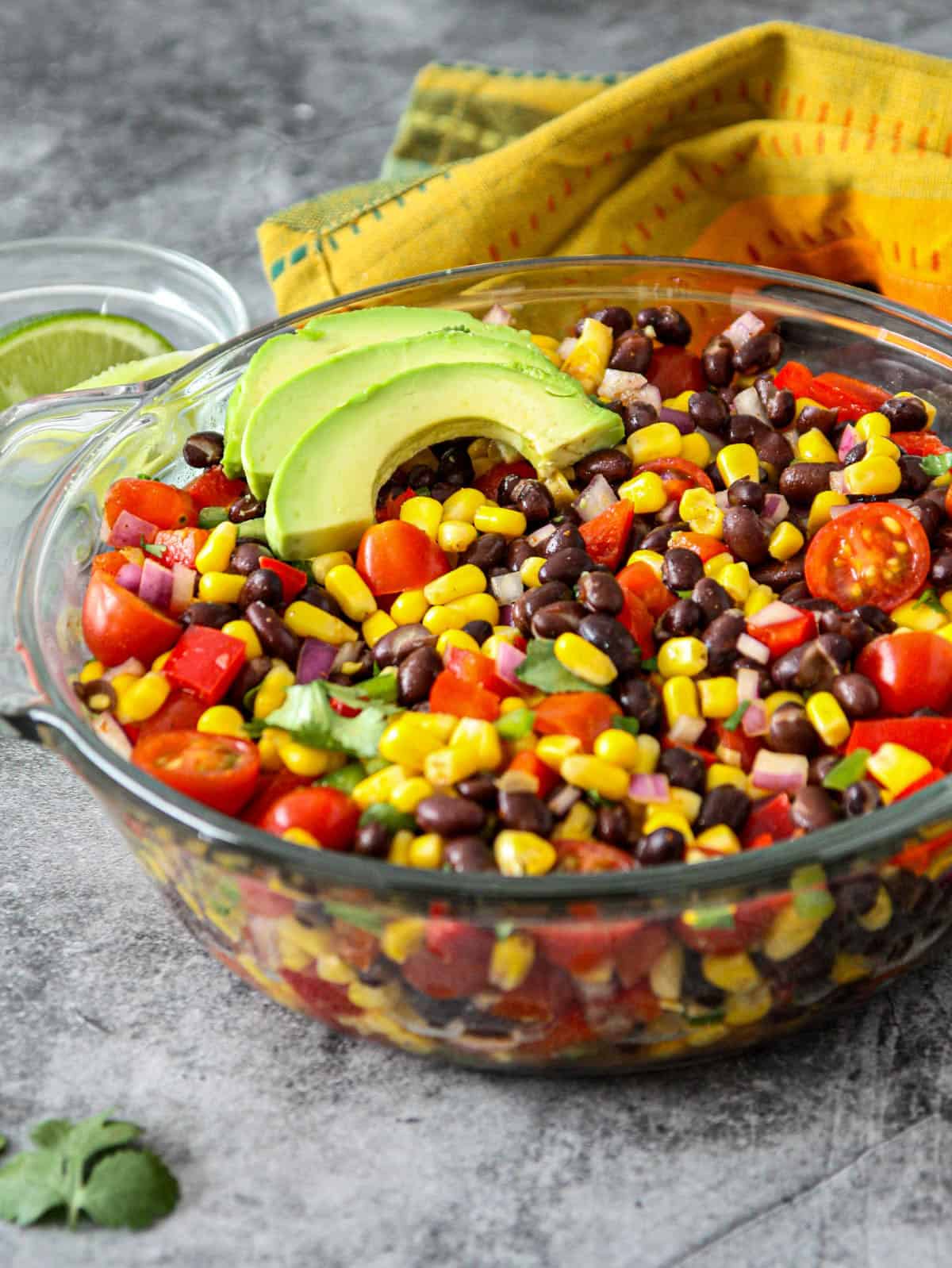 Fiesta corn and black bean salad in a glass bowl.