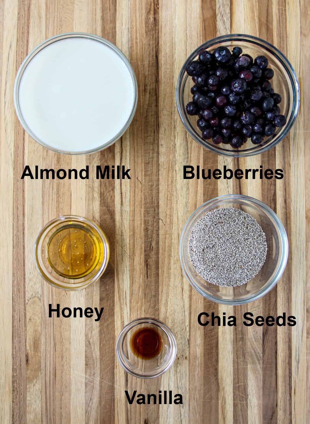 The ingredients for making this recipe in glass bowls on a wooden board.