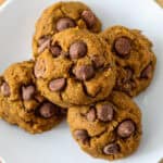 Five gluten free pumpkin cookies on a white plate.